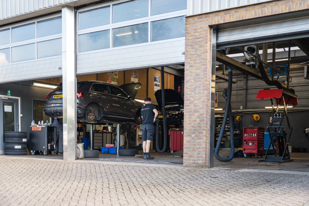 Een monteur aan het werk in onze werkplaats, van achteren gezien